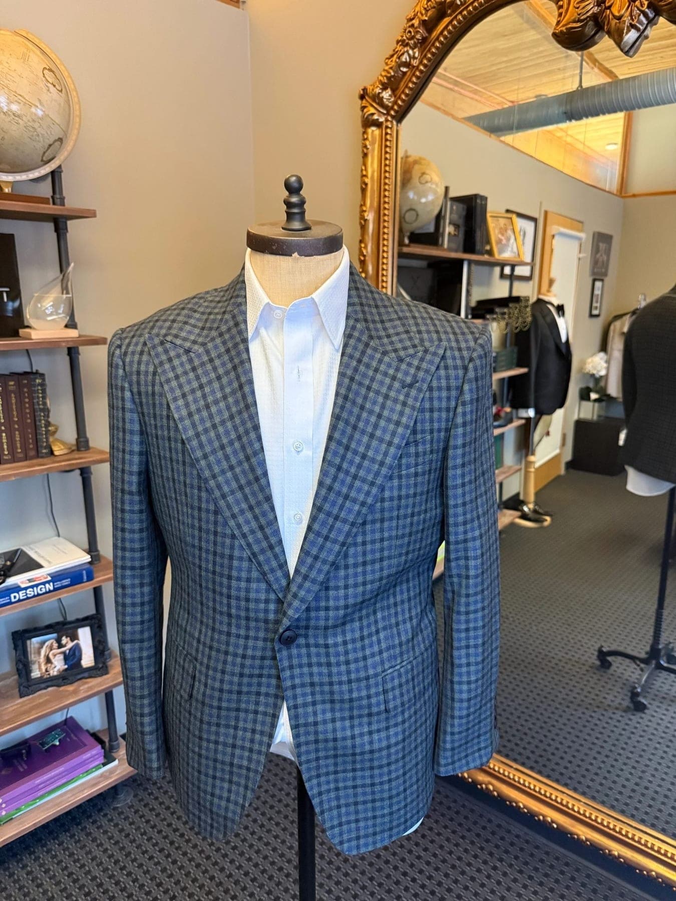 A blue check custom sports jacket on a form in the Conxeppt atelier