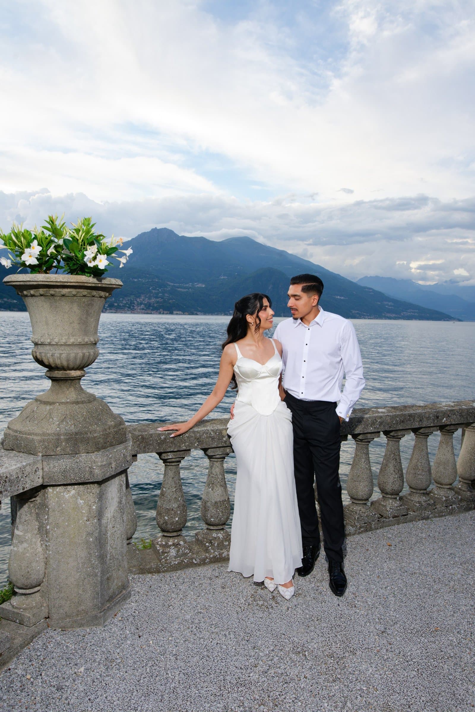 The couple at a stone balustrade above Lake Como in the evening