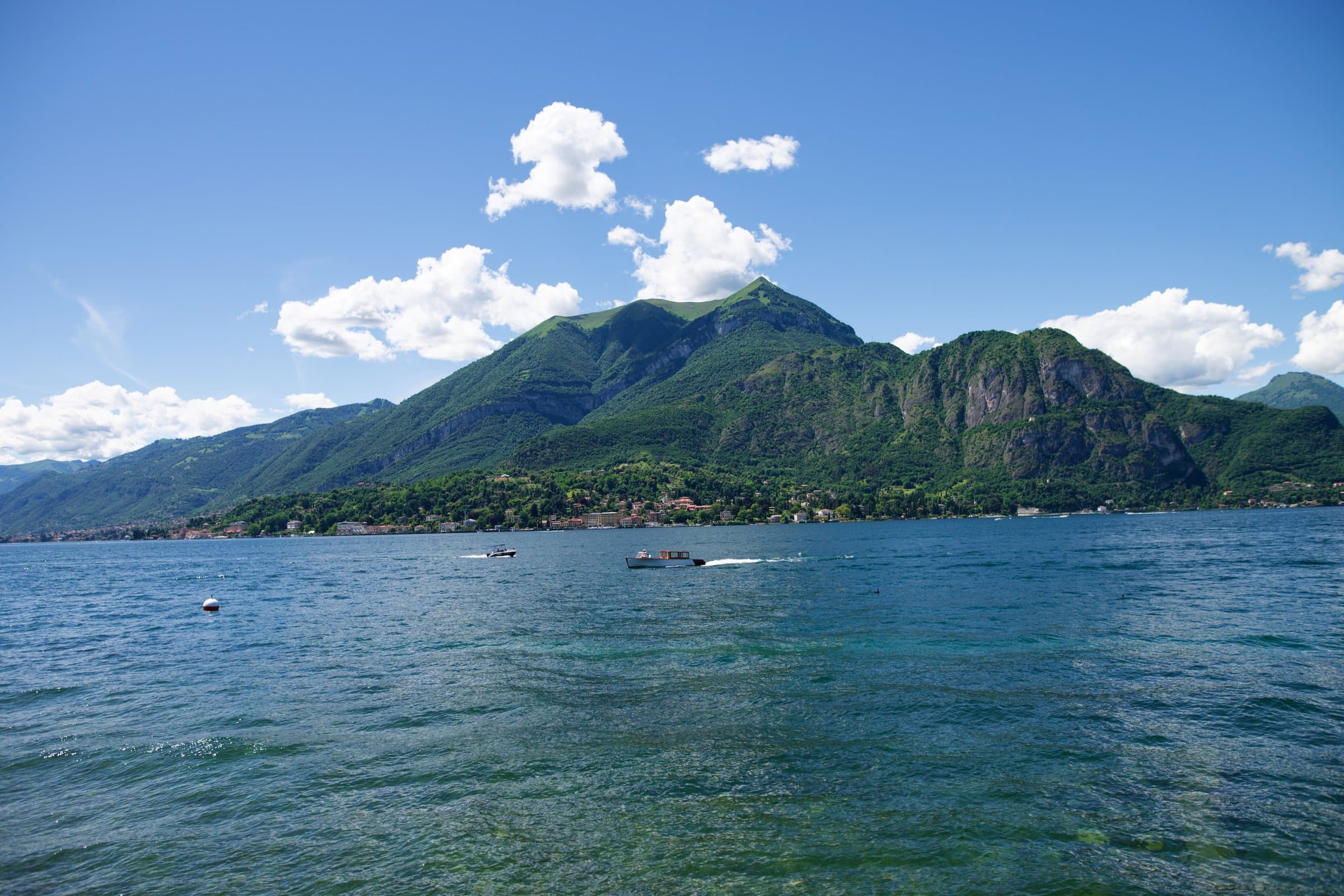Lake Como under a clear sky, the mountains across the water