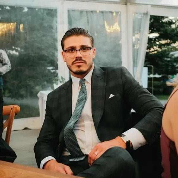 A Conxeppt client in a tailored suit at an outdoor event