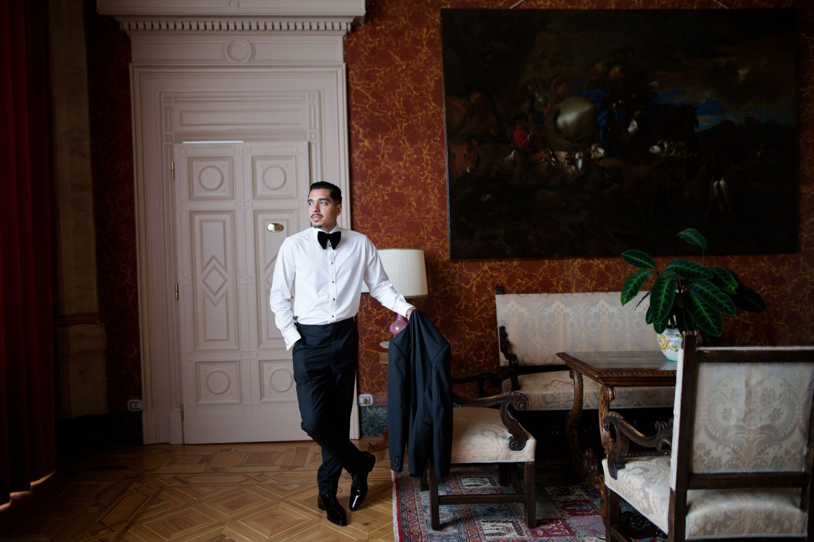 The Conxeppt collection of custom suits and tuxedos in Edmonton: a man in black tie in a villa salon
