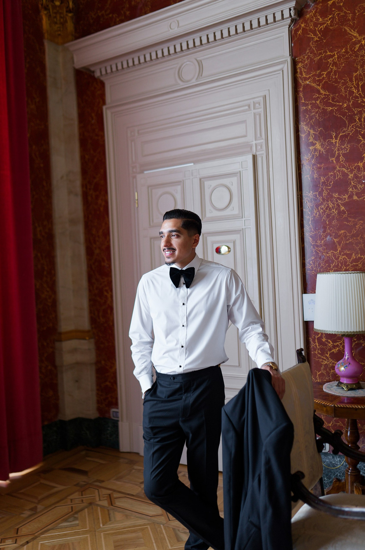 The groom wearing a white Conxeppt dress shirt before the Lake Como ceremony