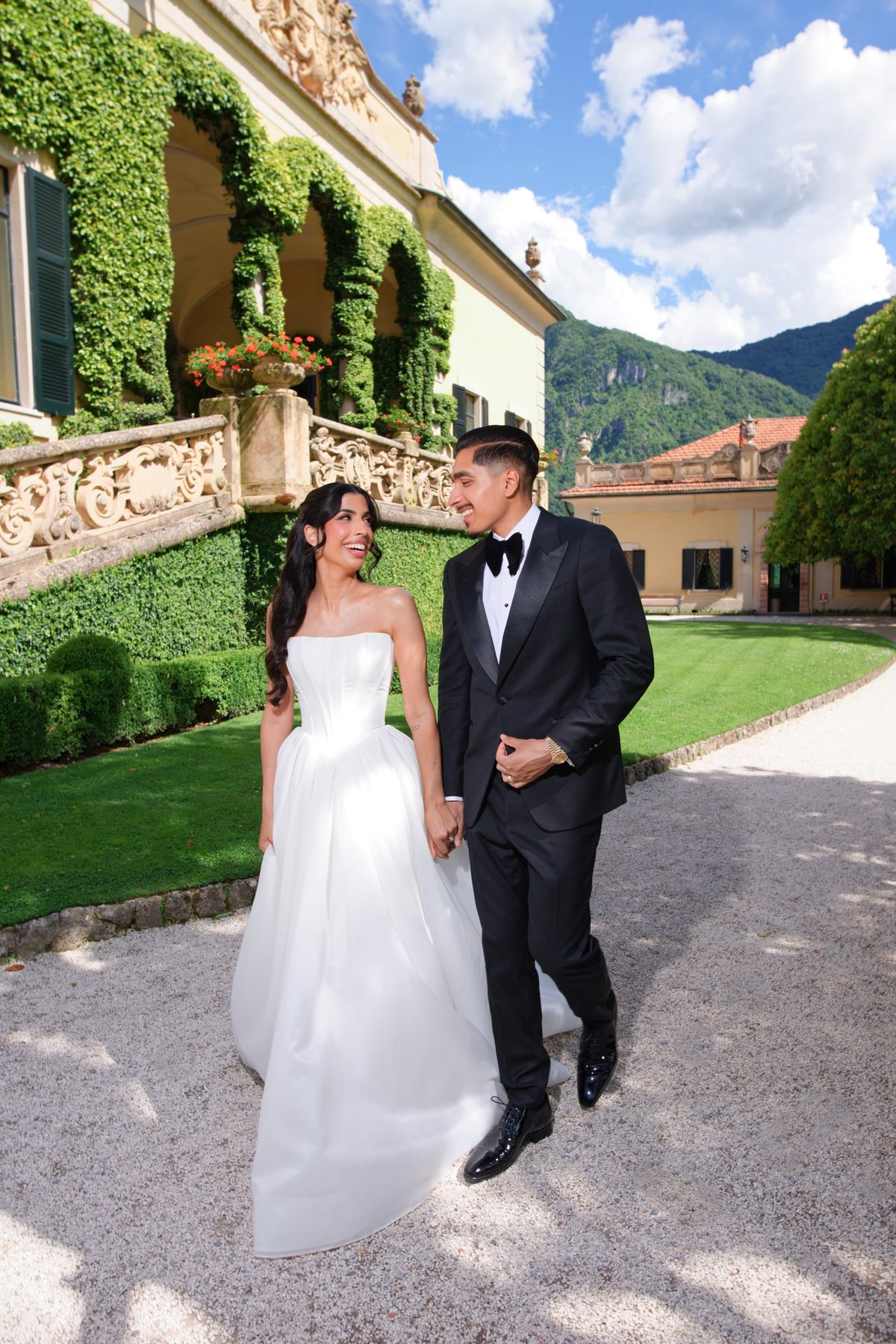 The bride against the villa balustrade under climbing vines