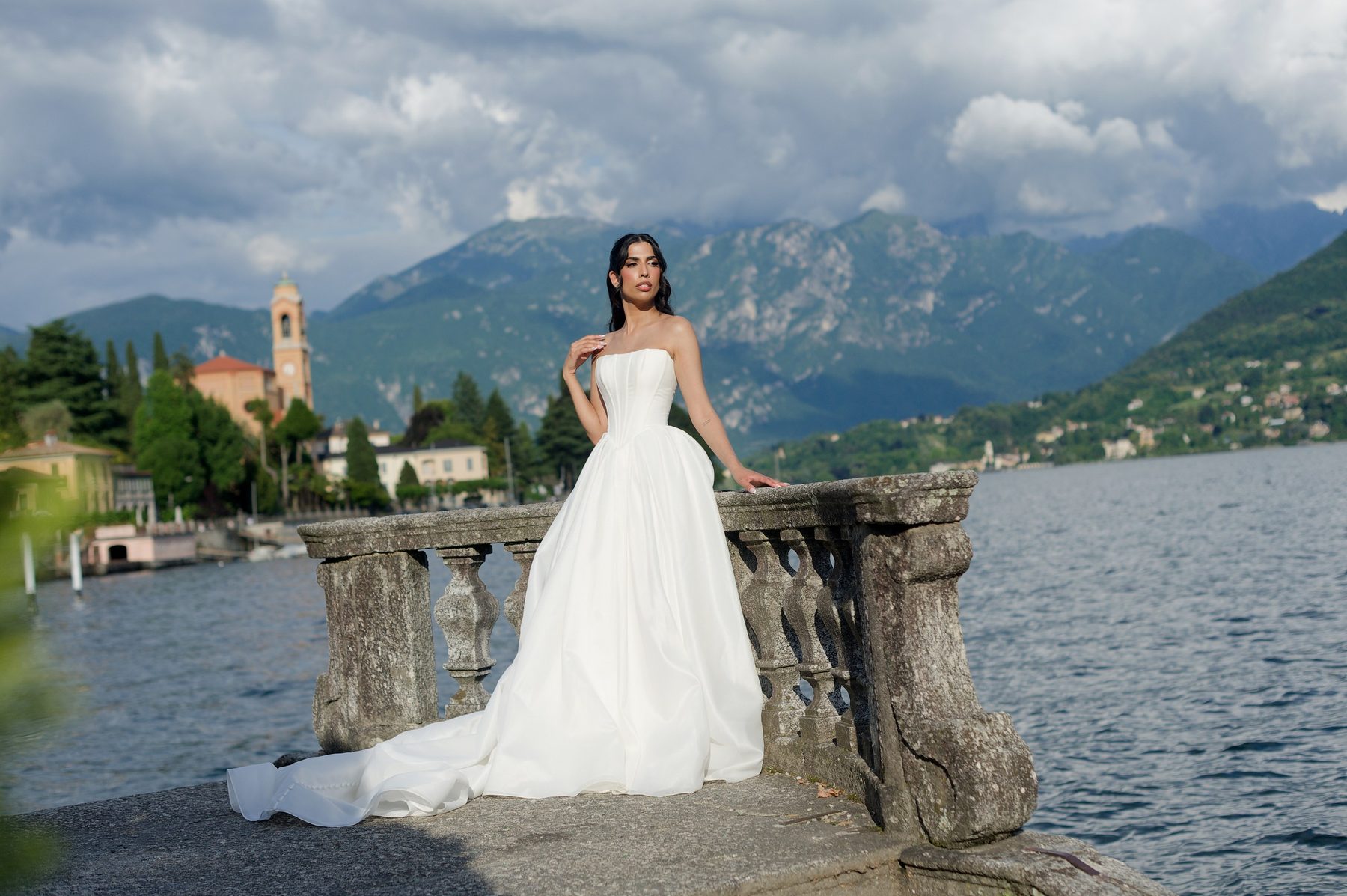 The bride at a stone balustrade on the shore of Lake Como