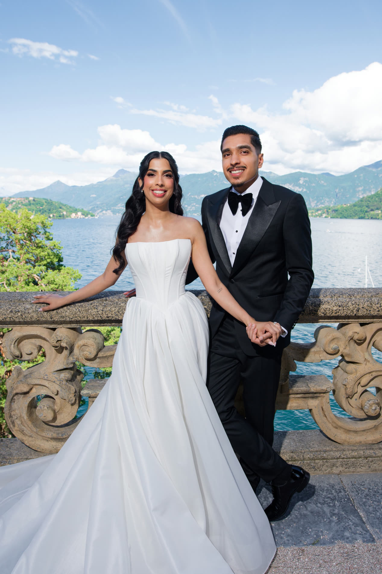 A couple on the villa balustrade, wedding suits tailored in Edmonton